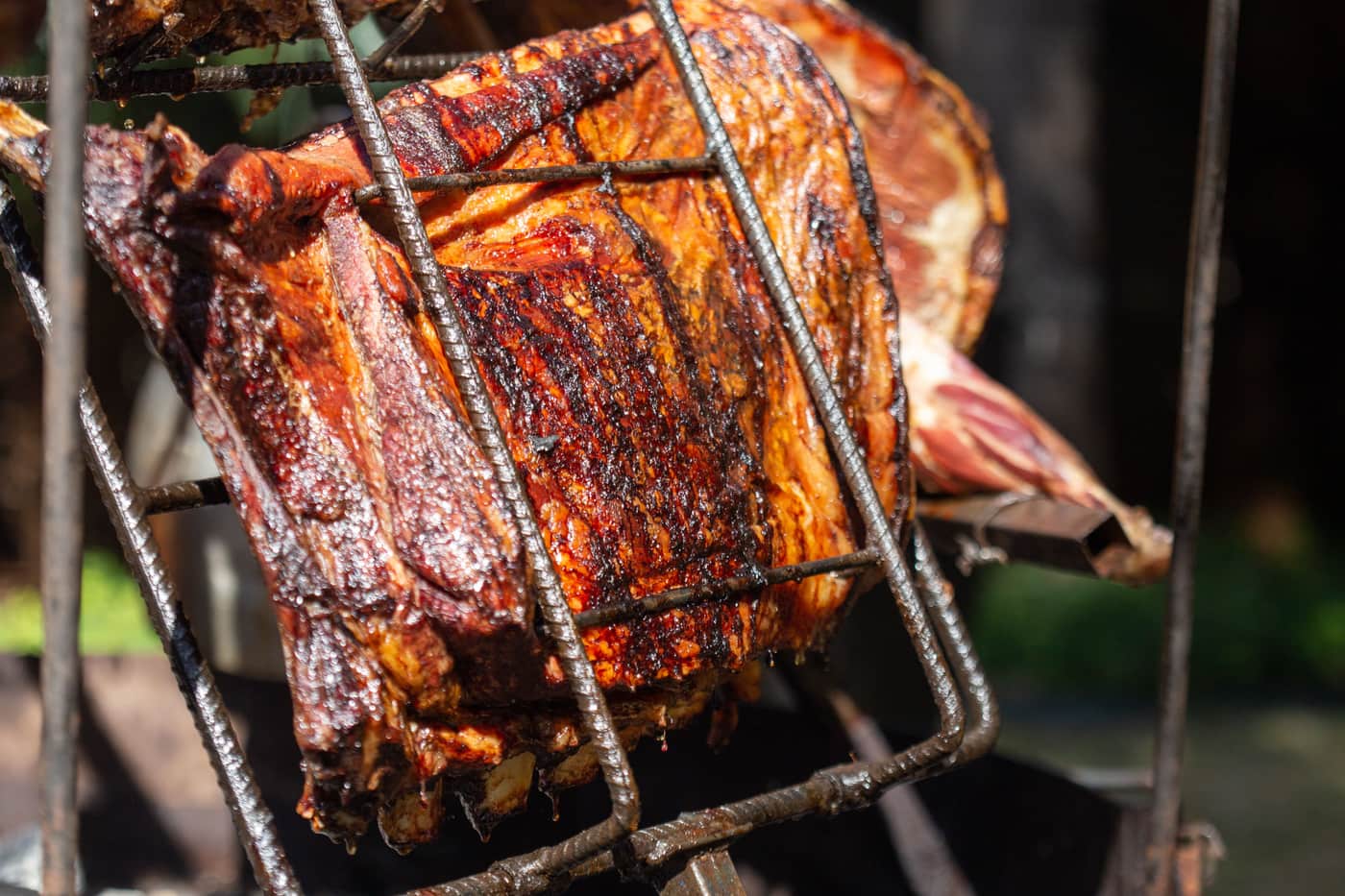 A wrapped brisket resting on a wooden board