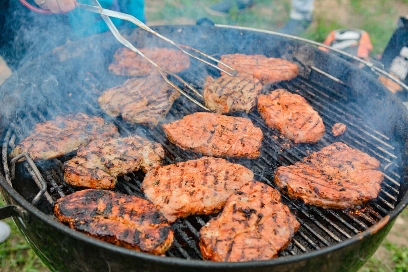 A meat thermometer probe inserted into a smoked brisket